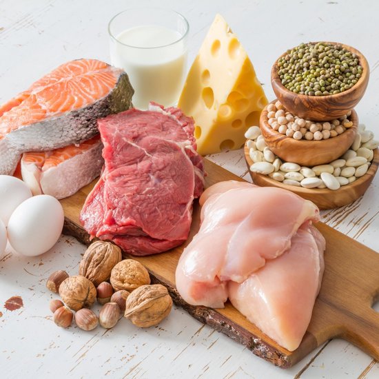 Meat, fish, eggs and cheese on a wooden board